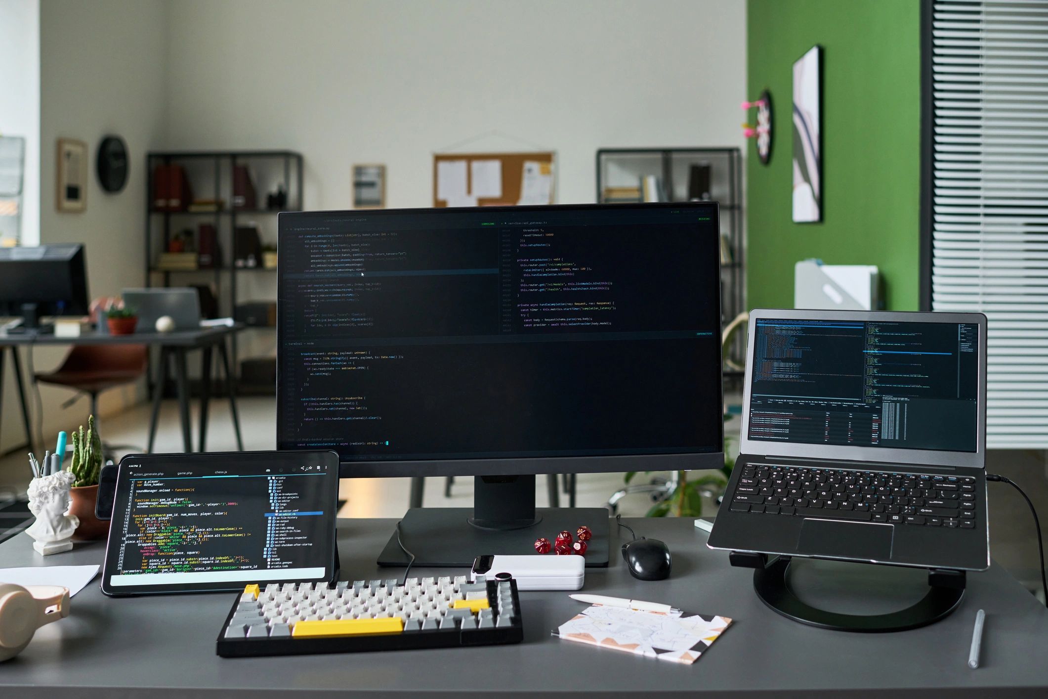 Software development workspace with code displayed across devices